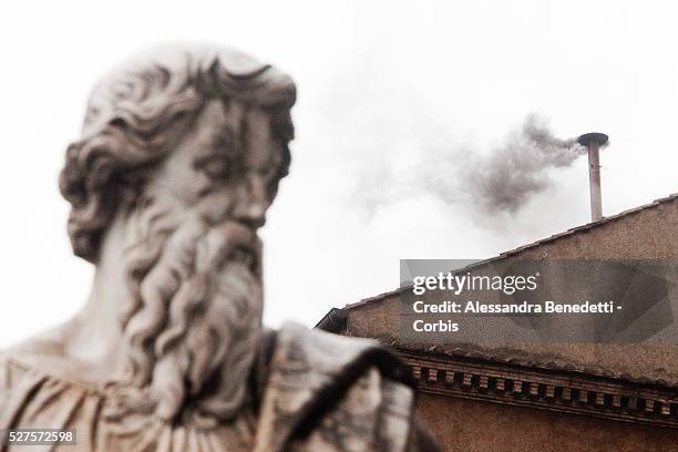 Black smoke billows out from a chimney on the roof of the Sistine Chapel indicating that the College of Cardinals have failed to elect a new Pope on...
