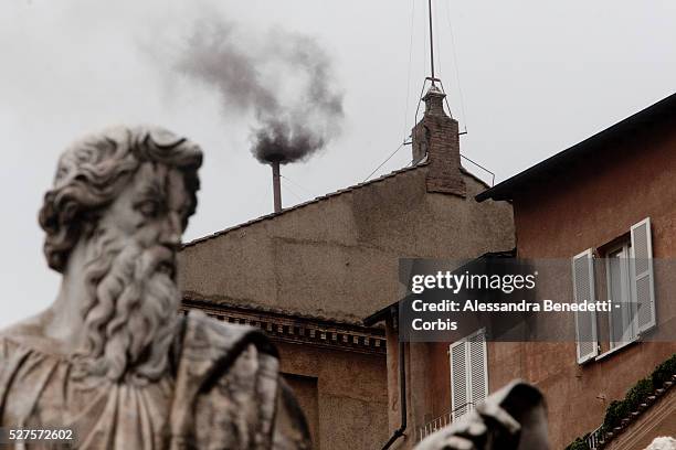 Black smoke billows out from a chimney on the roof of the Sistine Chapel indicating that the College of Cardinals have failed to elect a new Pope on...