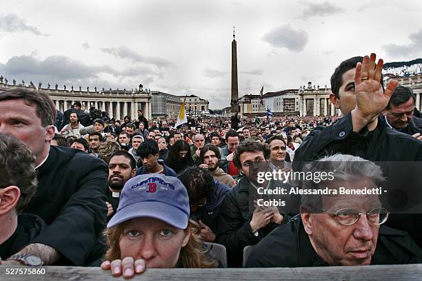 Catholic faithfuls kneel down as the newly elected Pope Benedict XVI appears on the balcony of St. Peter's Basilica after being elected by the...