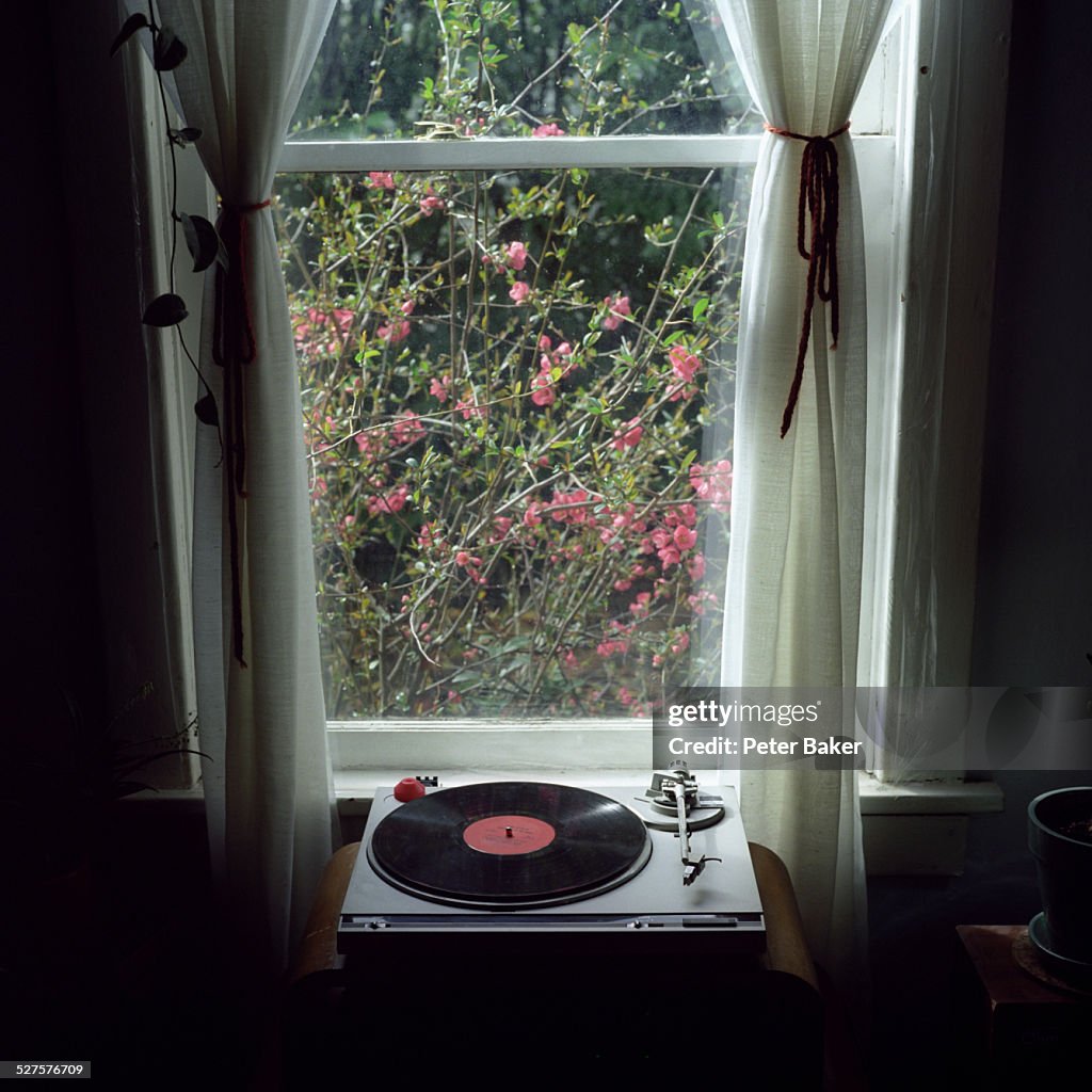 A record player in front of a window