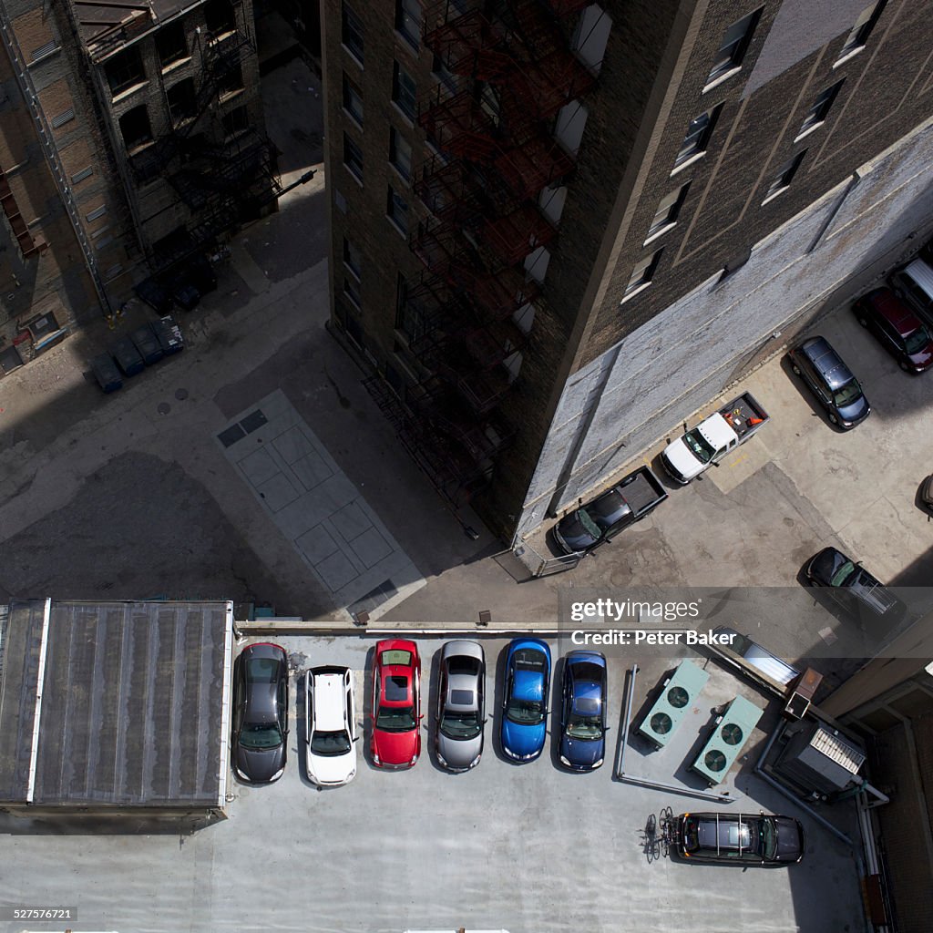 High angle view of city buildings and parked cars