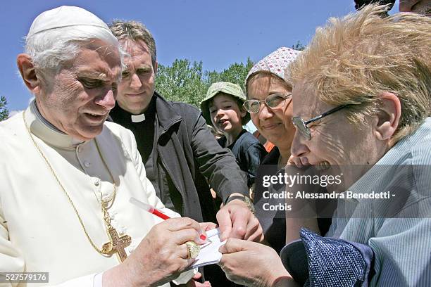 Pope Benedict XVI signs autographs to some faithfuls visiting the Monte Bianco white Mountain in the region of Valle d'Aosta.