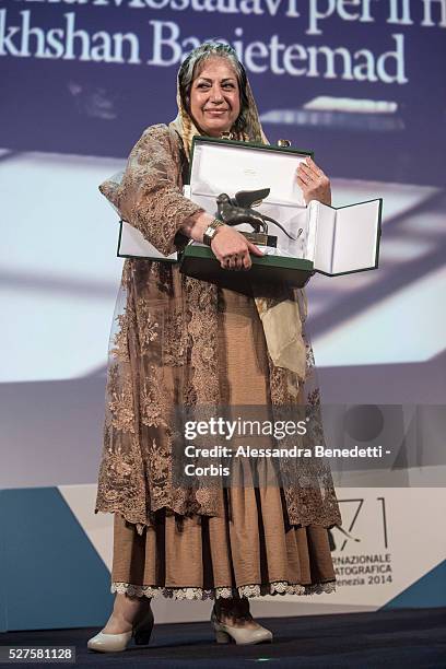 Director Rakhshan Banietemad poses on stage with the Best Screenplay award she received for her movie 'Ghesseha ' with Venezia Jury Member Jhumpa...