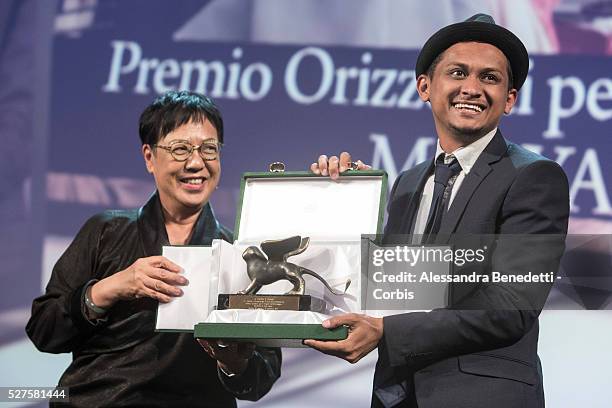 Director Sidi Saleh poses with his Orizzonti Award for Best Short Film for Maryam with Orizzonti Jury President Ann Hui on stage during the Closing...