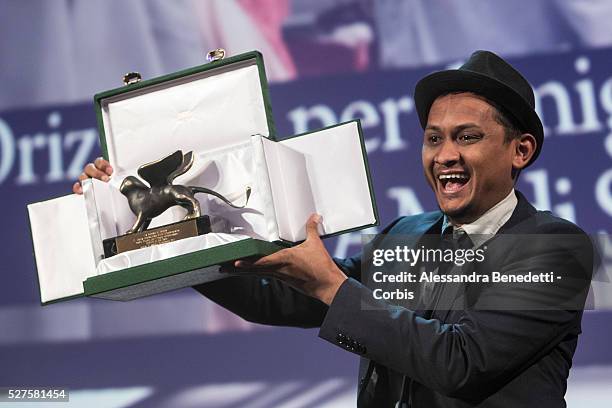 Director Sidi Saleh poses with his Orizzonti Award for Best Short Film for Maryam with Orizzonti Jury President Ann Hui on stage during the Closing...