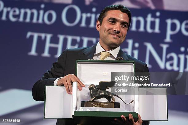 Director Naji Abu Nowar poses on stage with the Orizzonti award for Best Director for his movie 'Theeb' on stage during the Closing Ceremony of the...