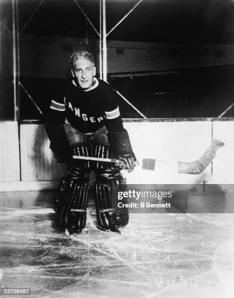 Portrait of Canadian-born professional hockey player, coach, and general manager Lester Patrick of the New York Rangers, posed on the ice and dressed...