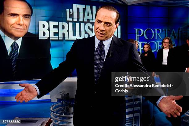 Italian Prime Minister Silvio Berlusconi gestures to reporters before the taping of the politics talk show "Porta a Porta" in Rome. After a...