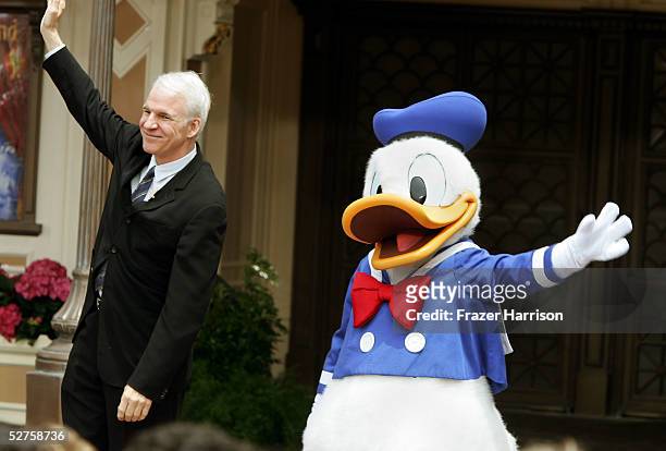 Donald Duck and former Disneyland cast member, actor Steve Martin unveil "Disneyland: The First 50 Magical Years," a historical exhibit during the...