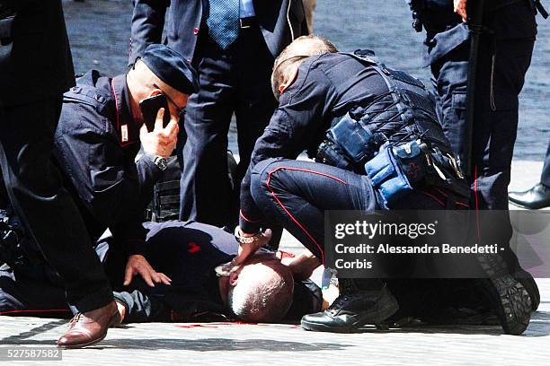 Carabinieri policeman lies on the ground outside Chigi Palace after being shot by Luigi Preti an italian unemployed man from Calabria. 2 carabinieri...
