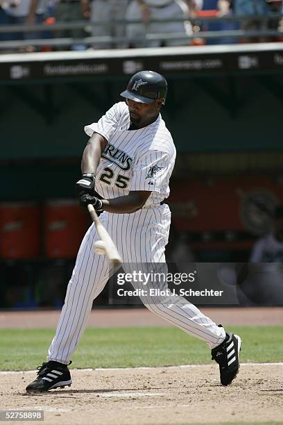 Carlos Delgado of the Florida Marlins makes contact with a pitch against the Cincinnati Reds on April 23, 2005 at Dolphins Stadium in Miami, Florida.