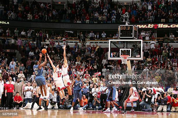 Gilbert Arenas of the Washington Wizards shoots the game winning shot over Kirk Hinrich and Tyson Chandler of the Chicago Bulls in Game five of the...
