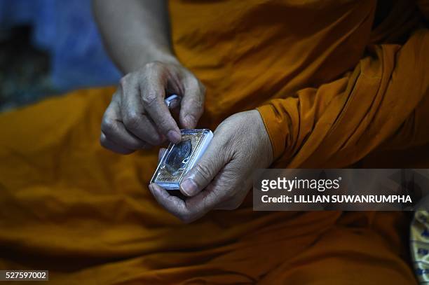 Thai Buddhist monk Phra Prommangkalachan, who had blessed Leicester City football players, shows one of the new amulets that Leicester players will...