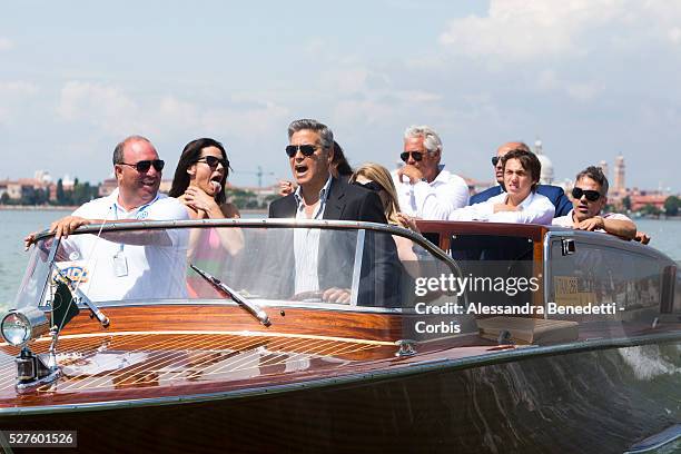 Sandra Bullock grimaces while George Clooney drives his boat on their way to the Venice Lido, to promote the movie Gravity presented out of...