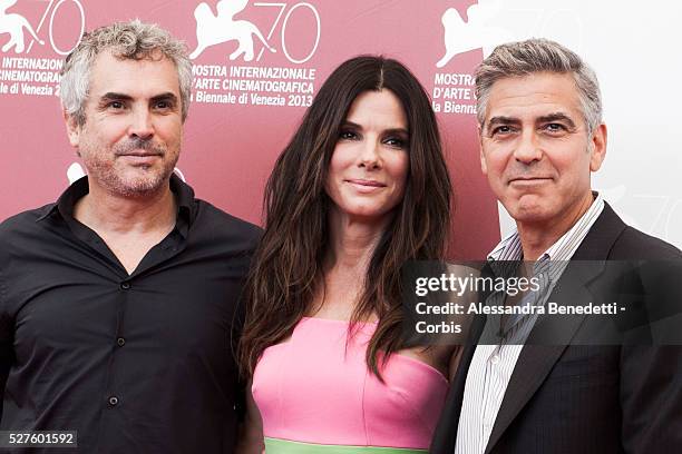 Sandra Bullock George Clooney and Alfonso Juaron attend the photocall of movie Gravity presented out of competition at the 70th International Venice...