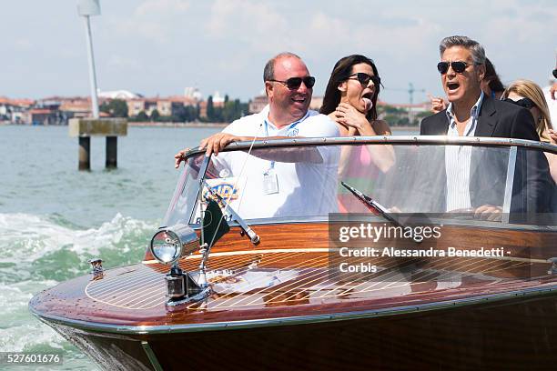 Sandra Bullock grimaces while George Clooney drives his boat on their way to the Venice Lido, to promote the movie Gravity presented out of...