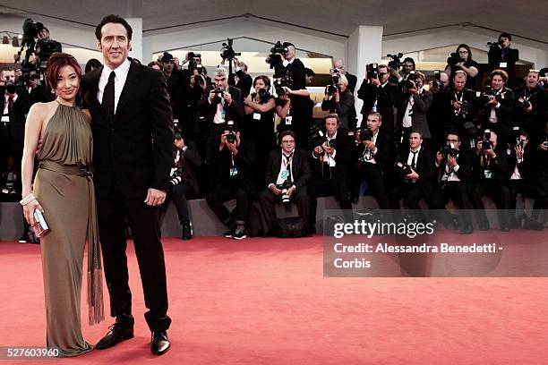 Nicolas Cage and wife Alice Kim kiss each other during the premiere of movie Joe, presnted in competition during the 70th International Venice film...