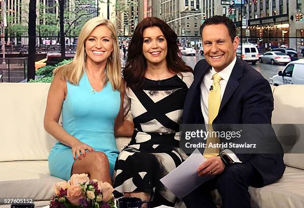Ainsley Earhardt, Bellamy Young and Brian Kilmeade pose for photos during "Fox & Friends" at FOX Studios on May 3, 2016 in New York City.