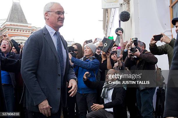 Leicester City's Italian football manager Claudio Ranieri is cheered by crowds of waiting fans as he arrives for lunch at an Italian restaurant in...