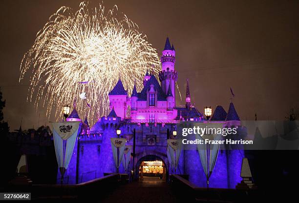 Fireworks explode over The Sleeping Beauty Castle as part of the Disney Premiere of "Remember...Dreams Come True" the biggest firework display in...