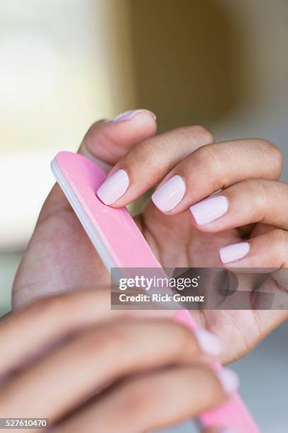 close of multi racial hands filing finger nails - nail file stock pictures, royalty-free photos & images