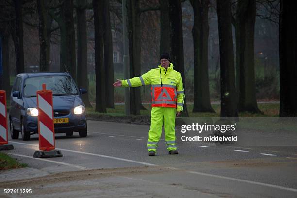 traffic warden busy with his work - verkeerspolitie stockfoto's en -beelden