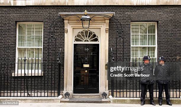 Two British police officers stand guard outside number 10 Downing Street, the official residence of Britain's current Prime Minister and leader of...