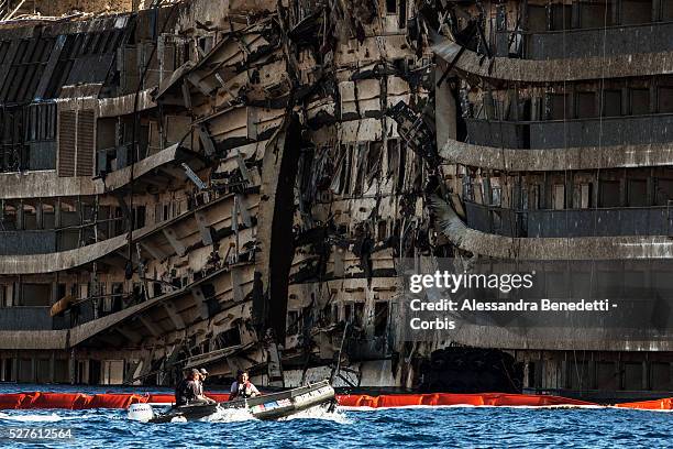 The Damaged Costa Concordia cruiseship is patroled by Italian Police and Technicinas the morning after the purbuckling operation successfully...