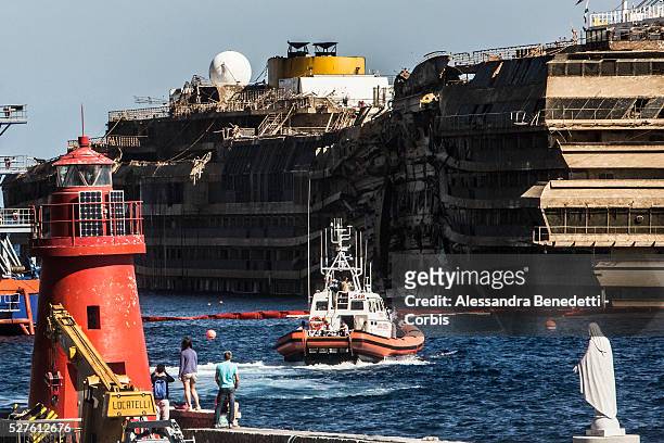 The Damaged Costa Concordia cruiseship is patroled by Italian Police and Technicinas the morning after the purbuckling operation successfully...