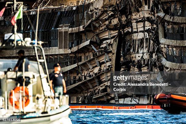 The Damaged Costa Concordia cruiseship is patroled by Italian Police and Technicinas the morning after the purbuckling operation successfully...
