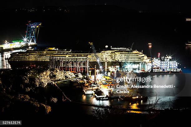 The Damaged Costa Concordia cruiseship is visible by Night after the purbuckling operation successfully uprighted it at 4:00 am in the Giglio...