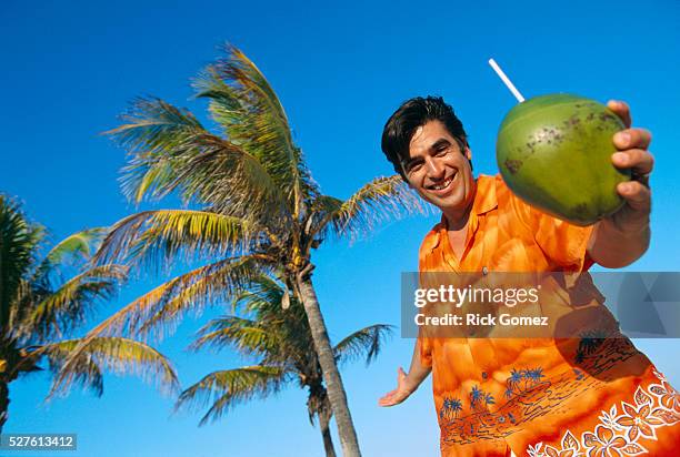 holding tropical drink by palm trees - coconut palm tree stock pictures, royalty-free photos & images