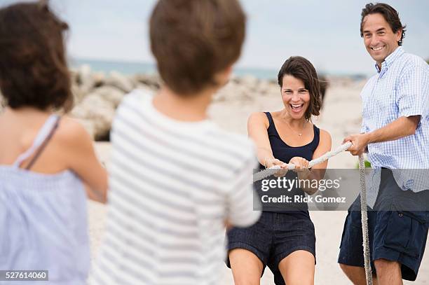 family playing tug of war - tug of war stock pictures, royalty-free photos & images