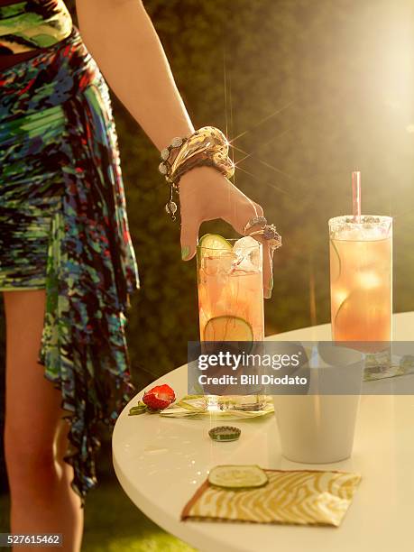 close-up of woman's hand holding drink - cocktail ring stock-fotos und bilder