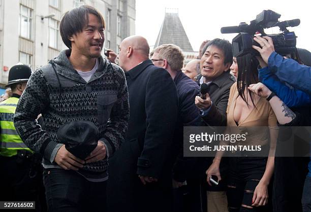 Leicester City's Japanese striker Shinji Okazaki is cheered by crowds of waiting fans as he arrives for lunch at an Italian restaurant in the centre...