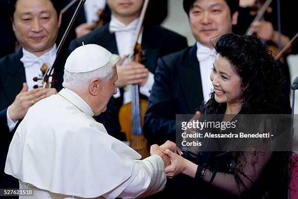 His holiness Pope Benedict XVI greets chinese soprano Lan Rao at the end of a special concert performed by the China Philharmonic Orchestra and...