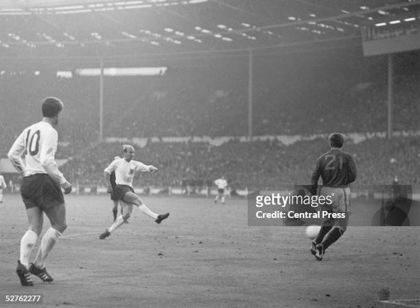 Bobby Charlton scores England's second goal as Portugal's Jose Carlos runs in to try and intercept during the World Cup semi-final match at Wembley,...