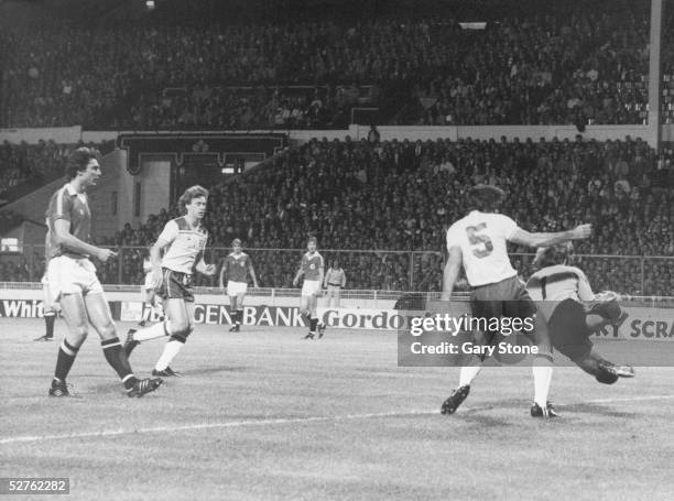 England player Dave Watson challenges Norwegian goalkeeper Tom Jacobsen, as Tony Woodcock looks on, during a World Cup qualifying match at Wembley,...