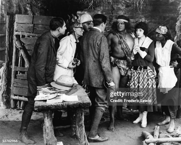 American actor Elmo Lincoln , as Tarzan, is surrounded by others in a scene from the silent film 'Tarzan of the Apes,' directed by Scott Sidney,...