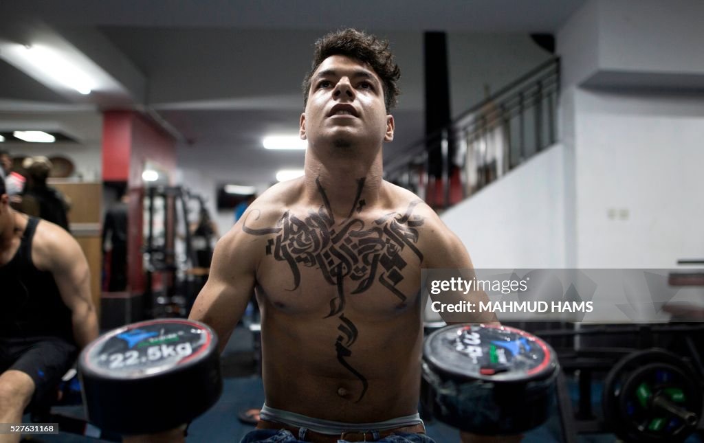Gaza Bodybuilder A Palestinian bodybuilder shows off Arabic calligraphy drawn by... News ...