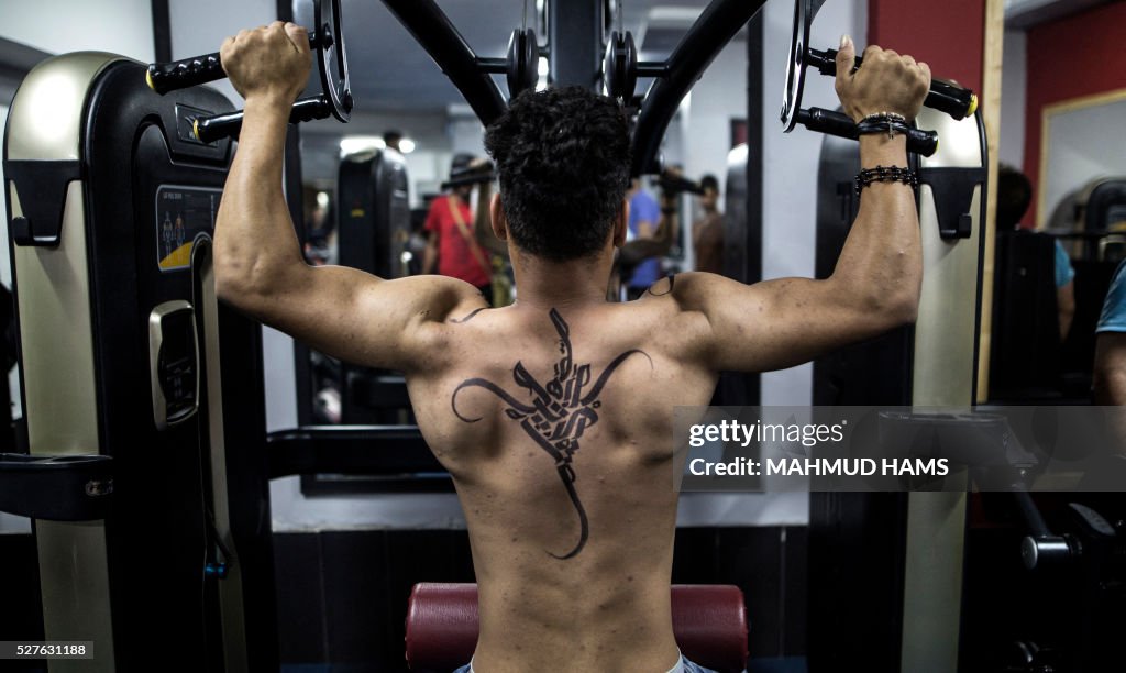 Gaza Bodybuilder A Palestinian bodybuilder shows off Arabic calligraphy drawn by... News ...
