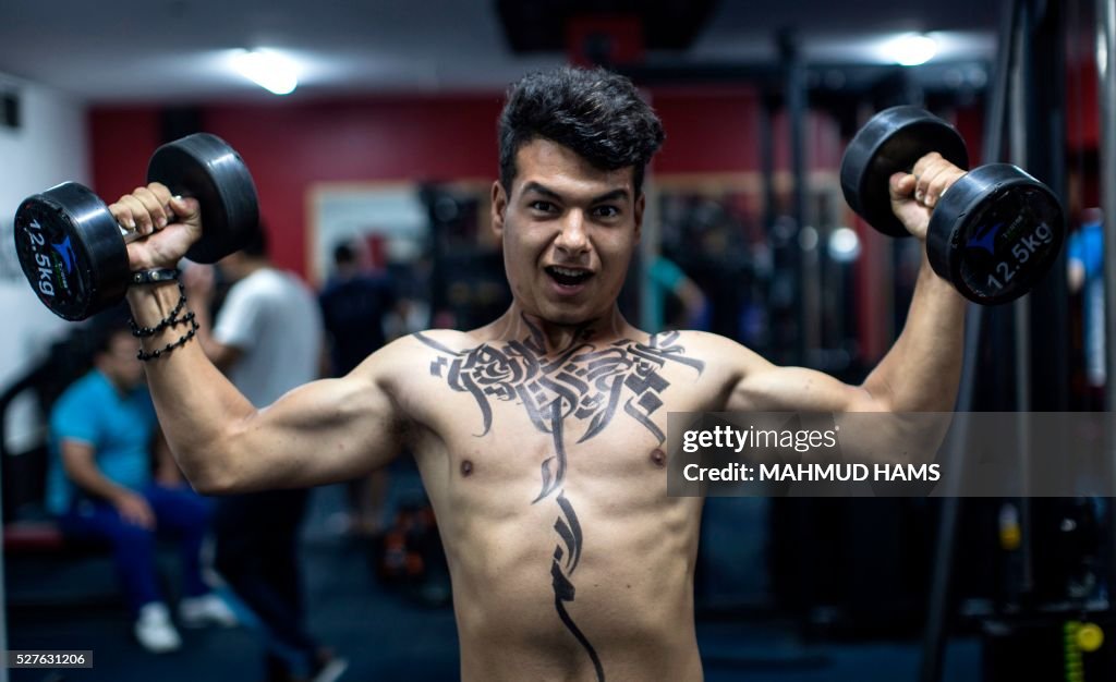 Gaza Bodybuilder A Palestinian bodybuilder shows off Arabic calligraphy drawn by... News ...