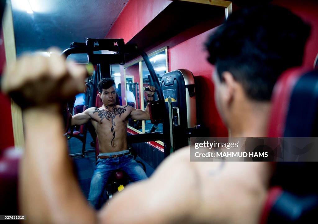 Gaza Bodybuilder A Palestinian bodybuilder shows off Arabic calligraphy drawn by... News ...