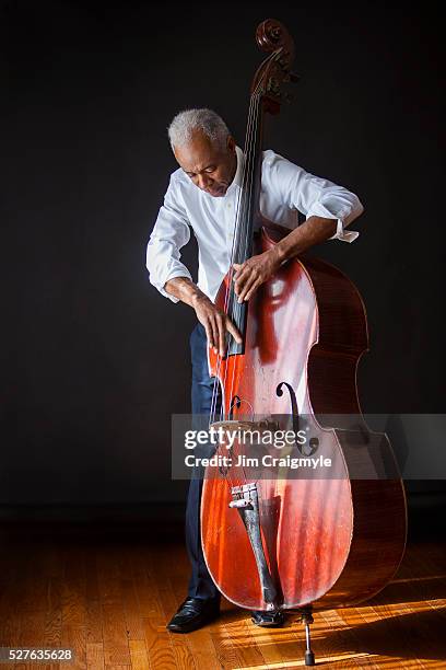 african american man 60's playing a double bass - kontrabass stock-fotos und bilder