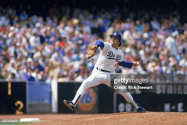 Pitcher Fernando Valenzuela of the Los Angeles Dodgers winds up for a pitch during a 1985 MLB season game at Dodger Stadium in Los Angeles,...