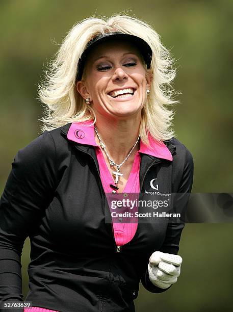 Danielle Amiee, winner of the Golf Channel's "Big Break III", laughs as she walks off the ninth tee during the first round of the Michelob Ultra Open...