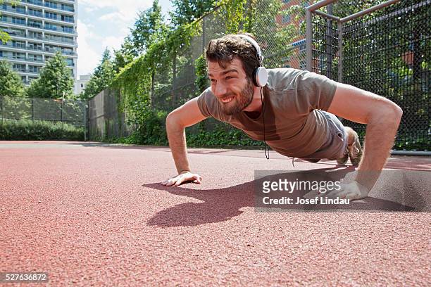 man exercising in playing field - sports field fence stock pictures, royalty-free photos & images