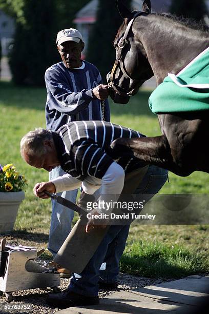Blacksmith Ray Amato, who works with trainer Todd Pletcher, files a freshly adhered horseshoe on one of the horses that they are preparing May 5,...