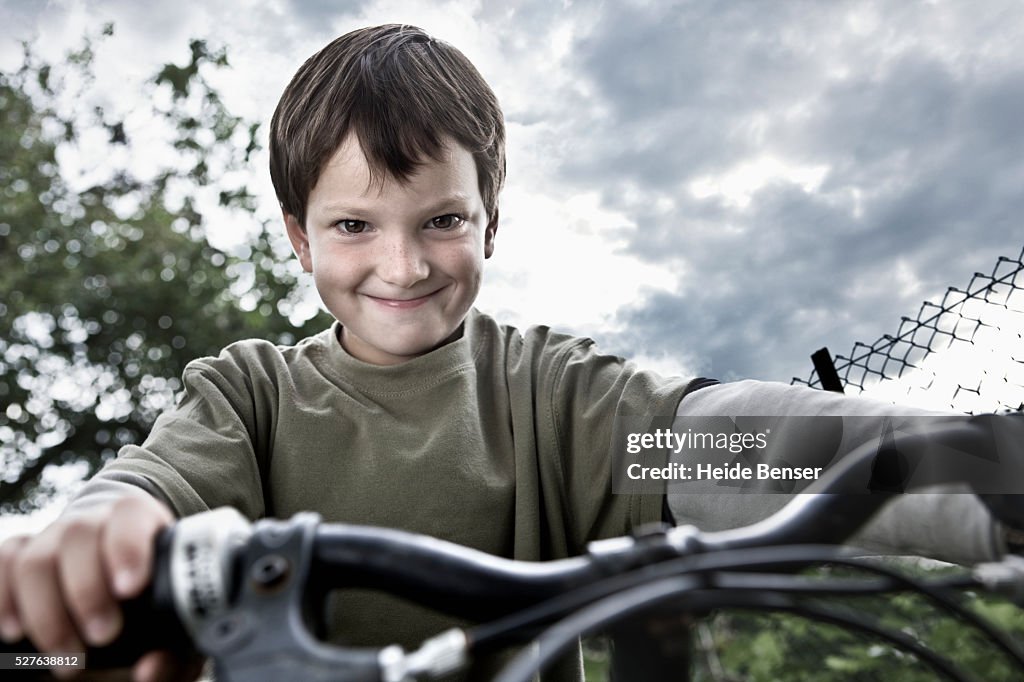 Portrait of boy (7-9) on bike making face