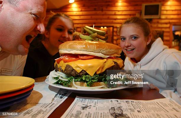 Rachel Fleagle her sister, Jessica and Scott Staub, all of Philadelphia pose with the burger May 5, 2005 at Denny's Beer Barrell in Clearfield,...